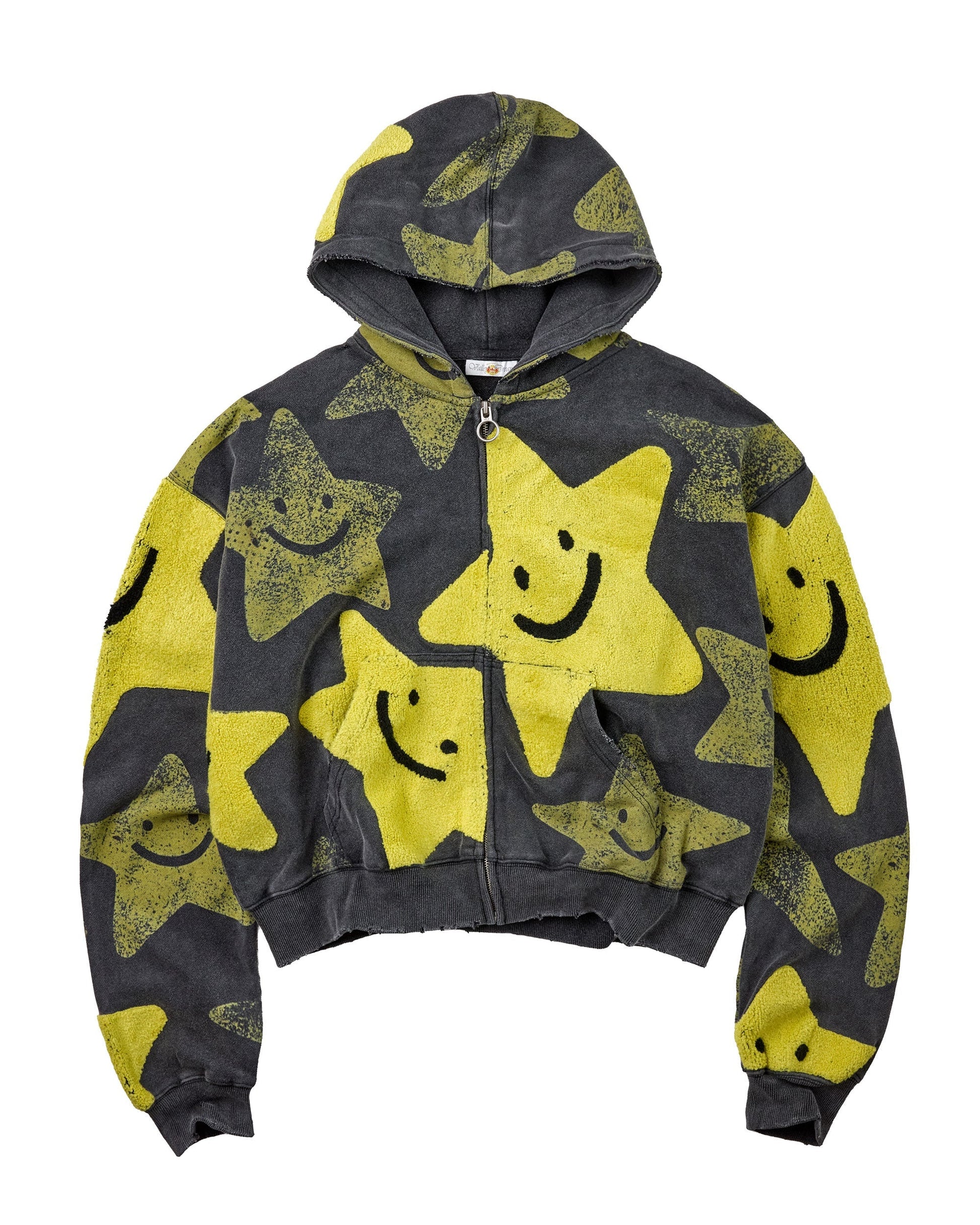 A cropped zip-up hoodie with a distressed yellow and dark gray star pattern, featuring smiley faces on the stars and a front zipper.