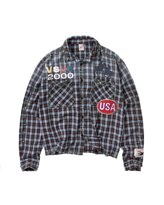 A plaid button-up shirt flannel with multicolor graphic patches, including 'VSU 2000' on the left chest, a polo player silhouette on the right chest, and a red oval 'USA' patch. The jacket features a brown, gray, and black plaid pattern with colorful embroidered details on the pockets and cuffs.