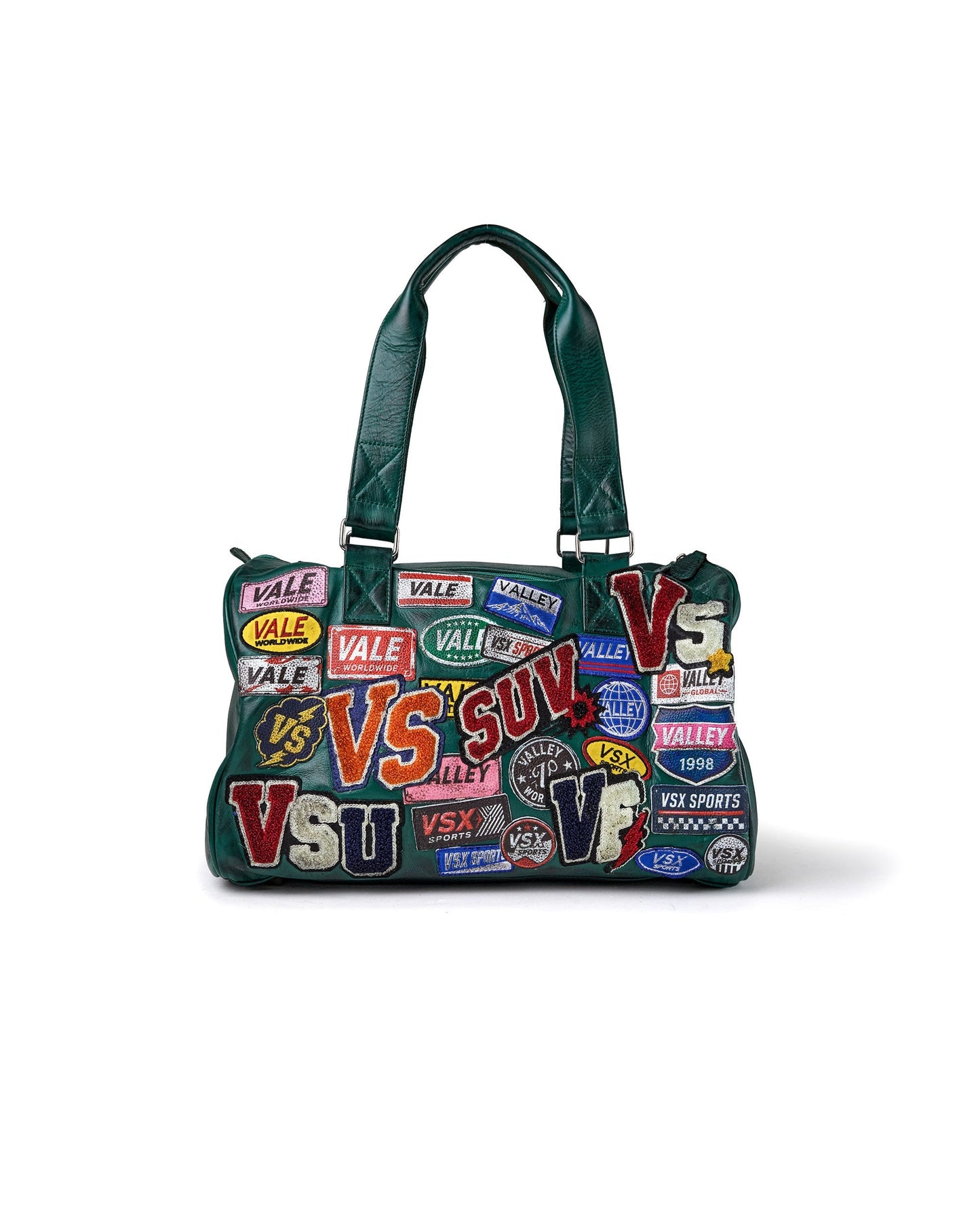 A dark green handbag covered in colorful vintage-style sports patches and text, including 'VALE', 'VS', 'SUV', and 'VSU', with dark green handles, shown on a white background.