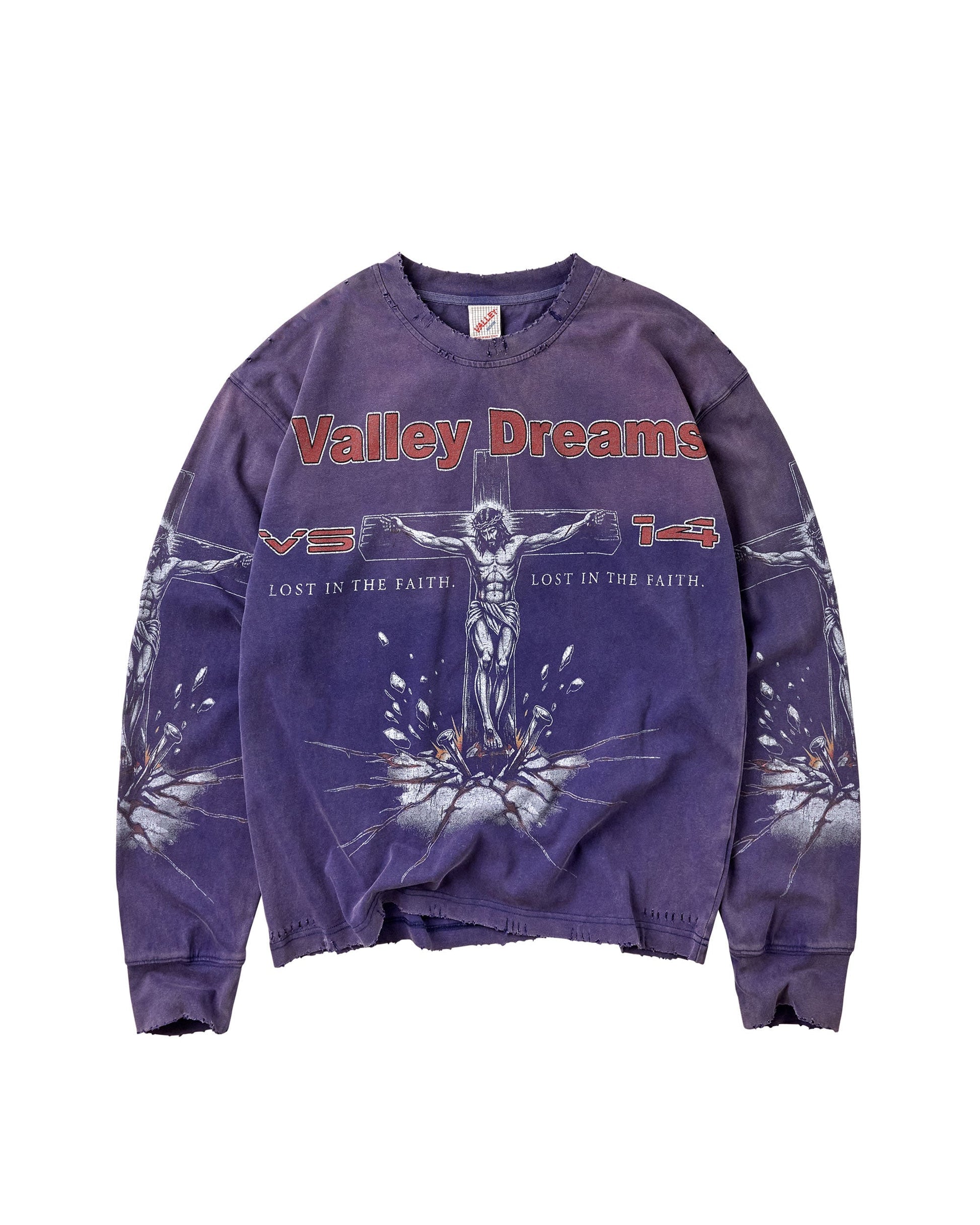 A purple mineral-wash crewneck sweatshirt featuring a graphic of Jesus on the cross with the text 'Valley Dreams' in red across the chest, displayed flat against a white background.